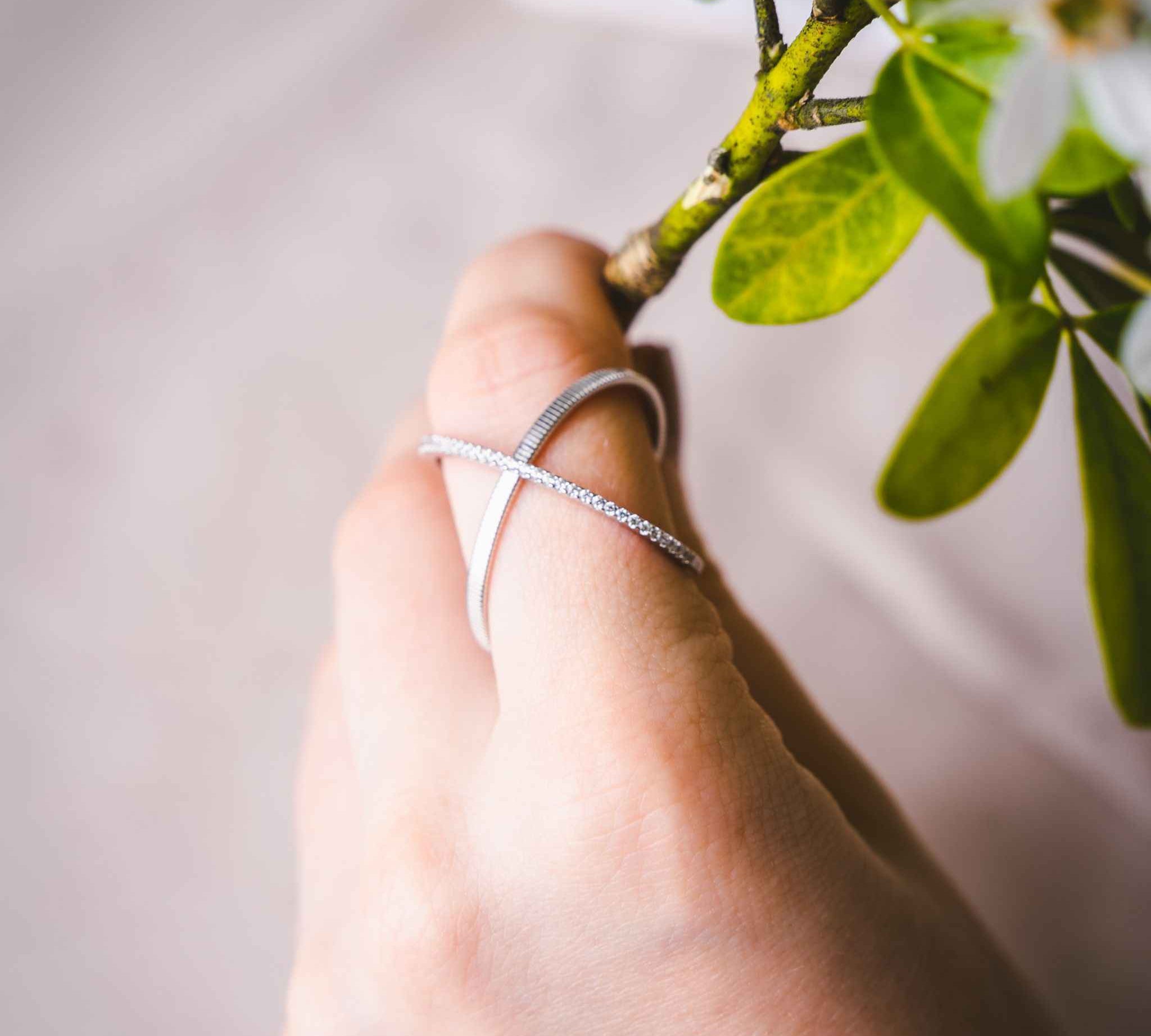 Close-up view of Waverly Silver Cross Ring showcasing its matte band and etching pattern.