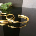 Detailed view of the gold foil texture on the bangle, emphasizing its unique design and luxury appeal.