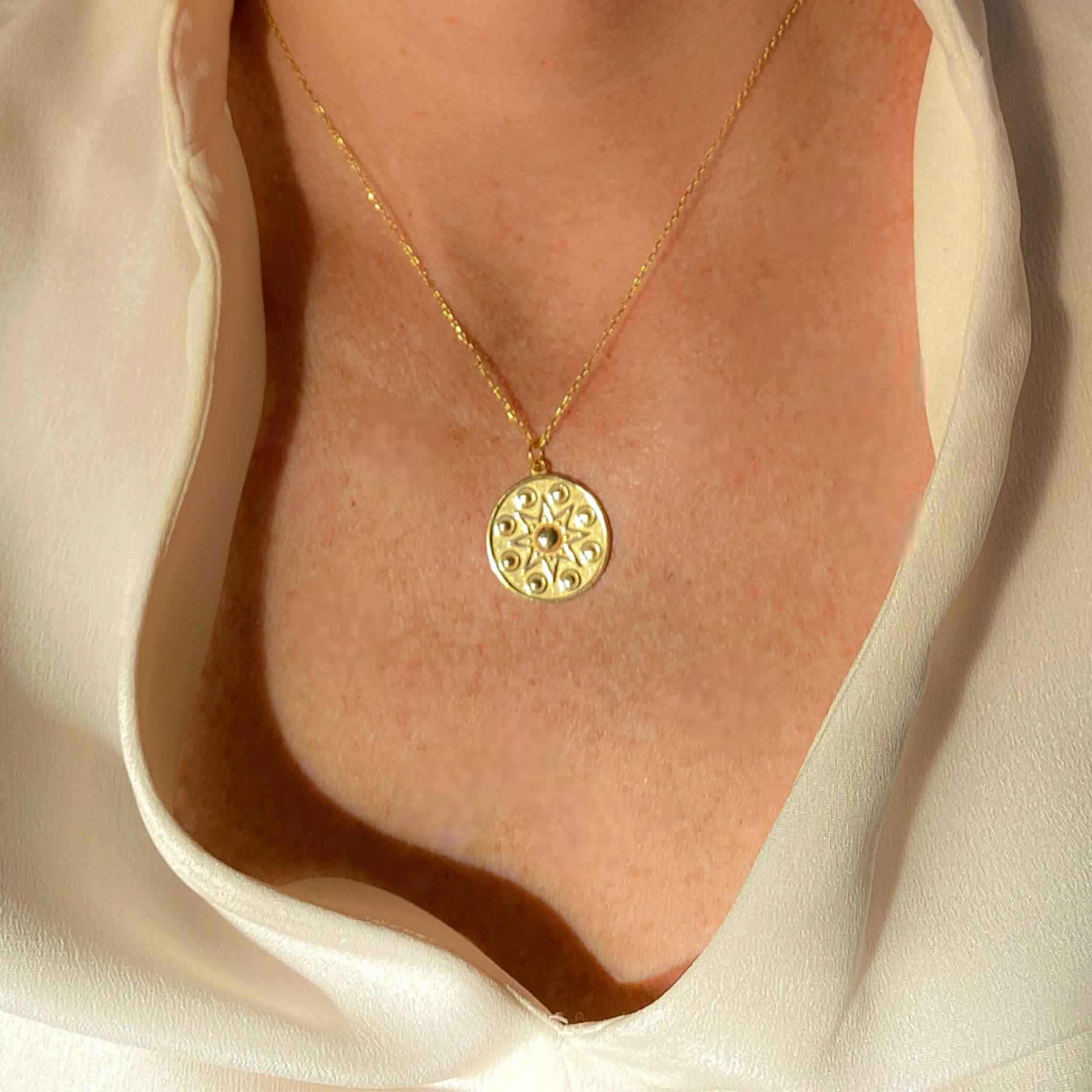 Close-up view of 18k gold star pendant necklace - Modern quiet luxury trend by Alessandra James.