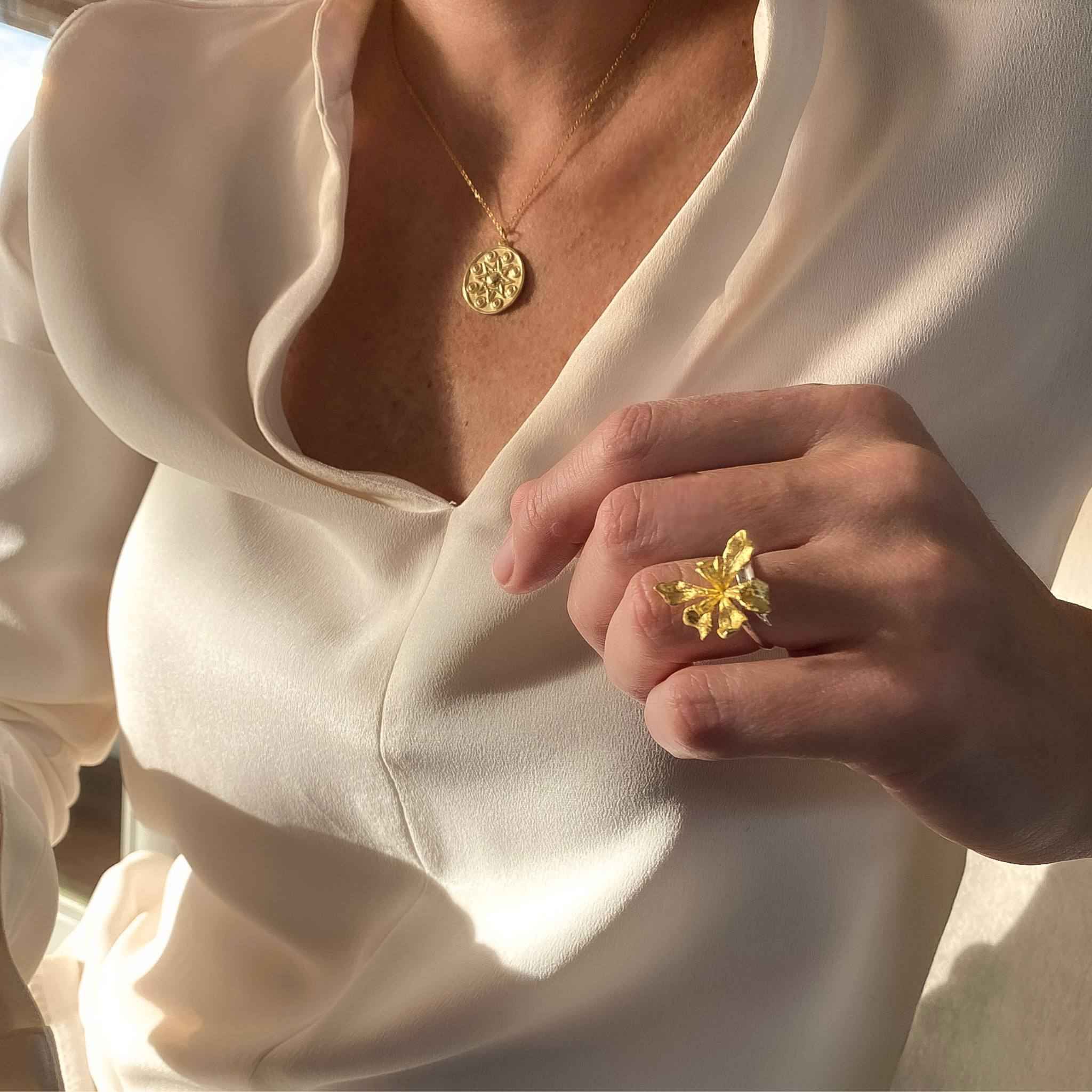 Styled view of the gold Iris Cocktail Ring, highlighting the detailed iris adornment - a timeless piece for the modern woman.