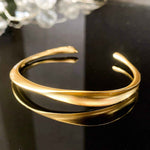 Close-up of Gold Wave Bangle's graceful design, showcasing its timeless elegance.