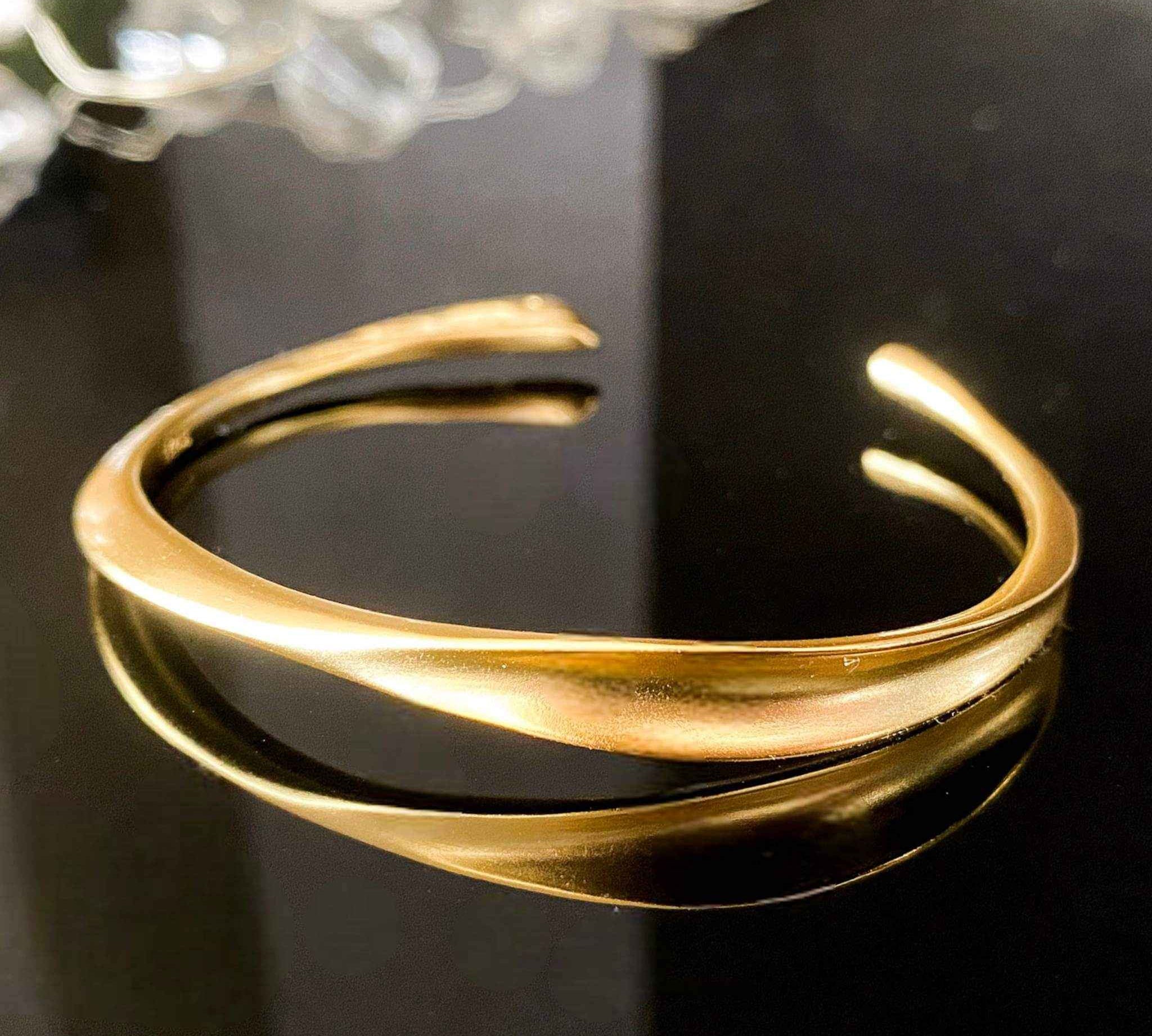Close-up of Gold Wave Bangle's graceful design, showcasing its timeless elegance.