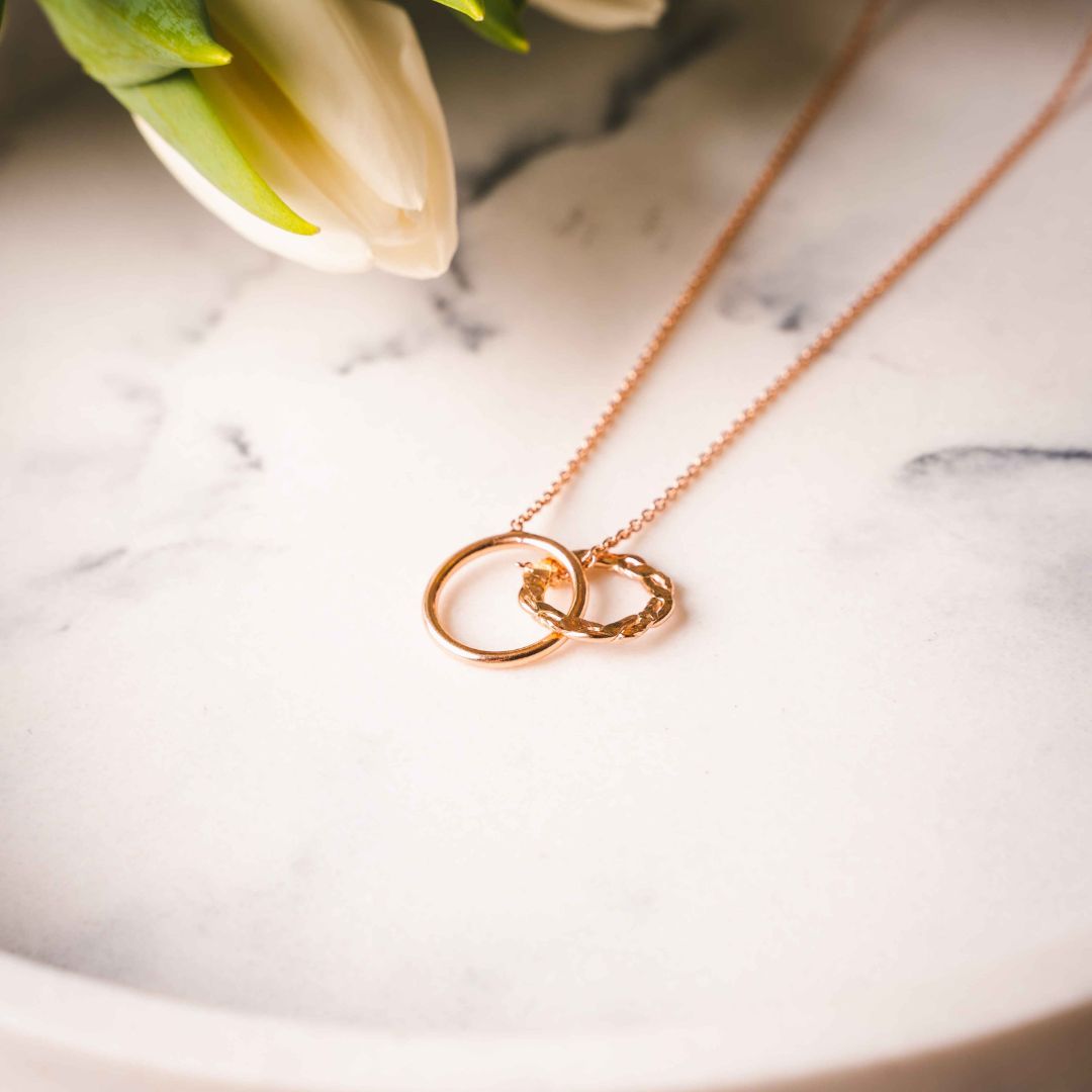 Styled view of the Interlocking Rings Necklace, highlighting its feminine and luxury appeal.