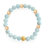 Close-up view of women's Aquamarine and Gold Beaded Bracelet set by Alessandra James.