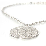 Profile view of the Melany medallion necklace, a fashionable accessory for day or night.