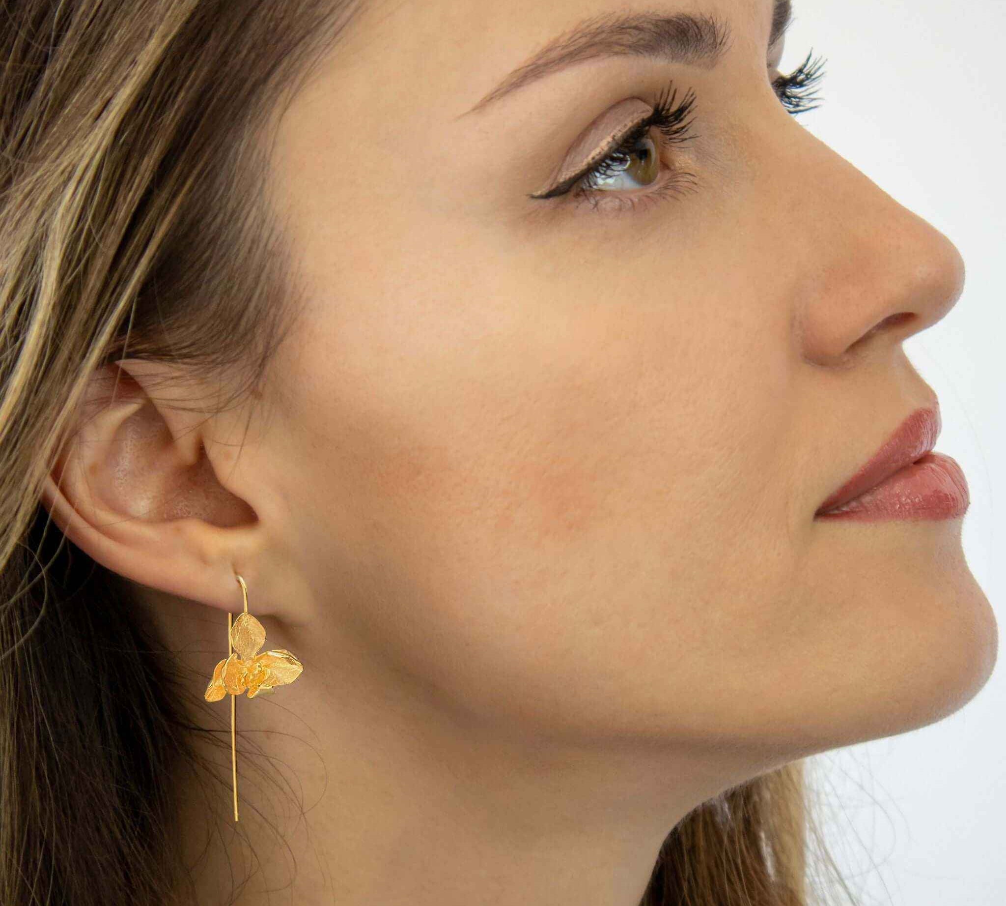Close-up view of Handcrafted Orchid Drop Earrings in Gold by Alessandra James.