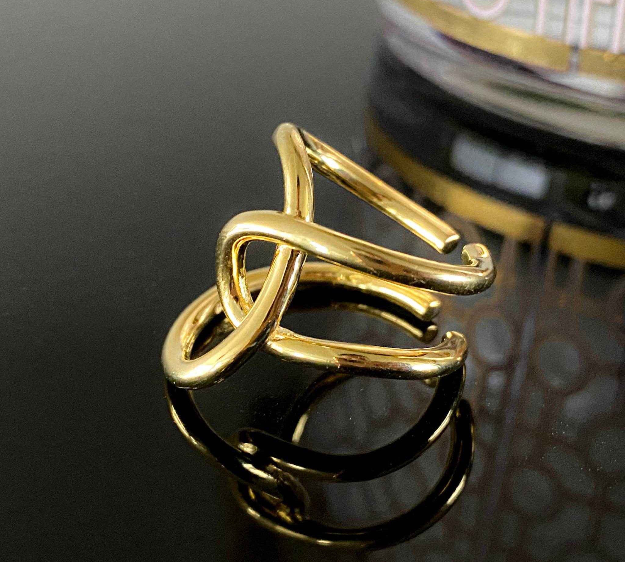 Close-up view of the intricate design of the Asymmetric Twist Ring in sterling silver with 18k gold plating.