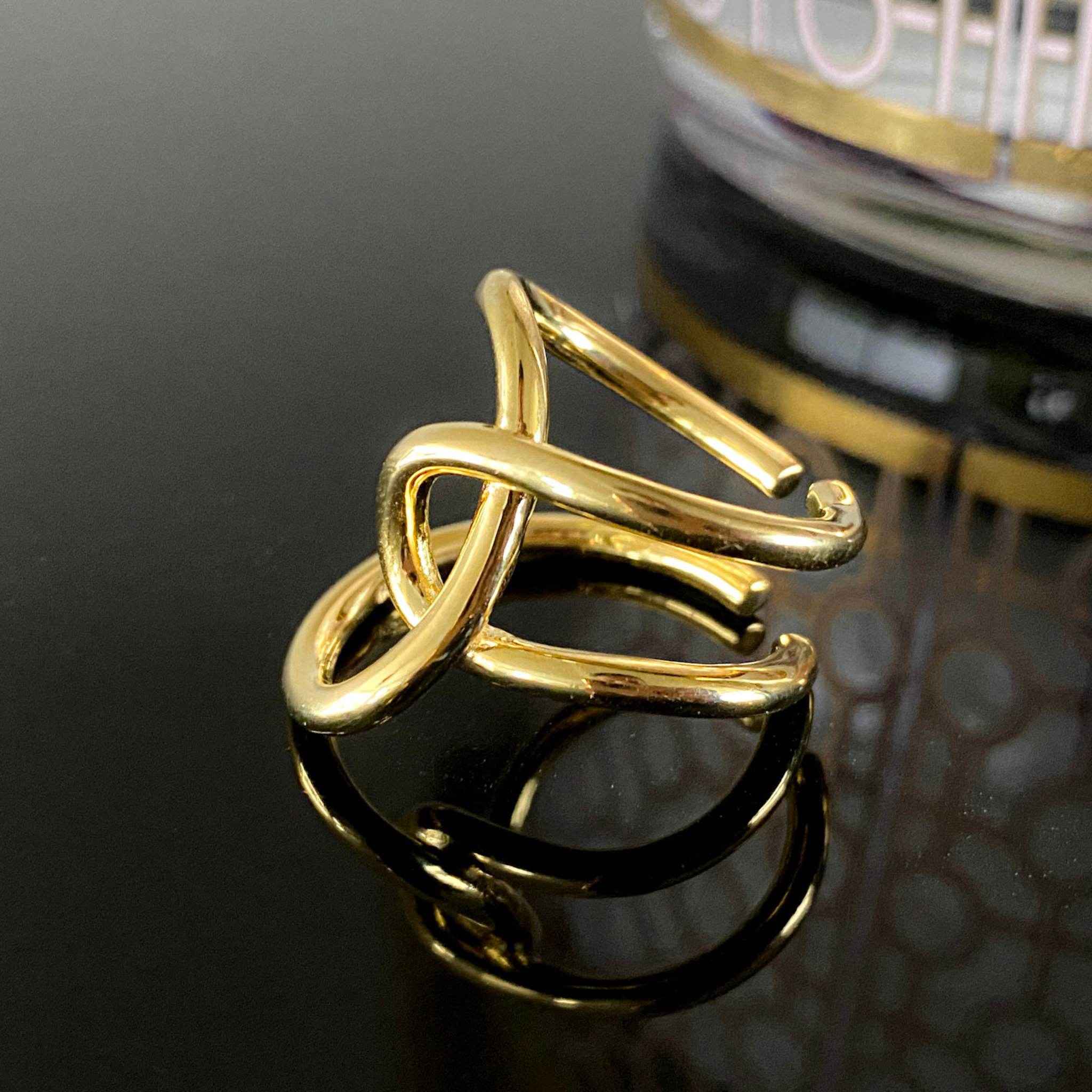 Close-up view of the intricate design of the Asymmetric Twist Ring in sterling silver with 18k gold plating.