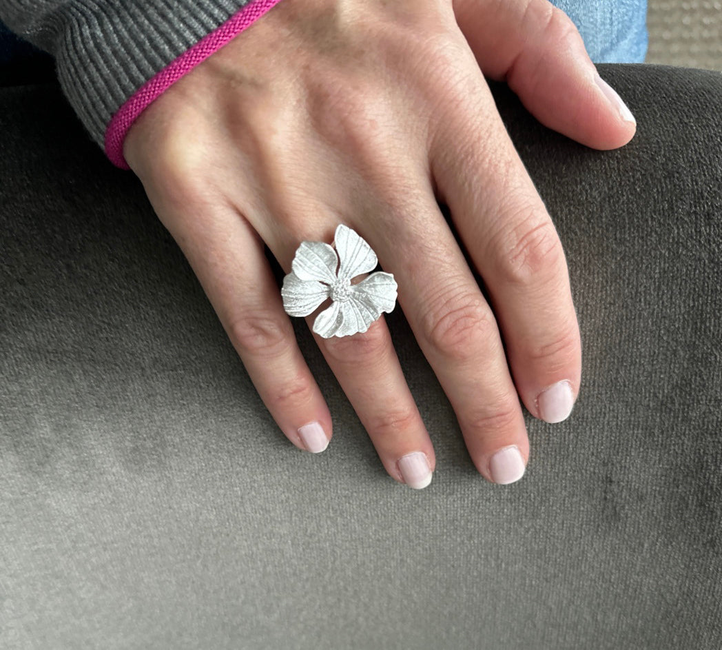 Closeup of silver Peony Cocktail Ring showing the delicately etched petals.