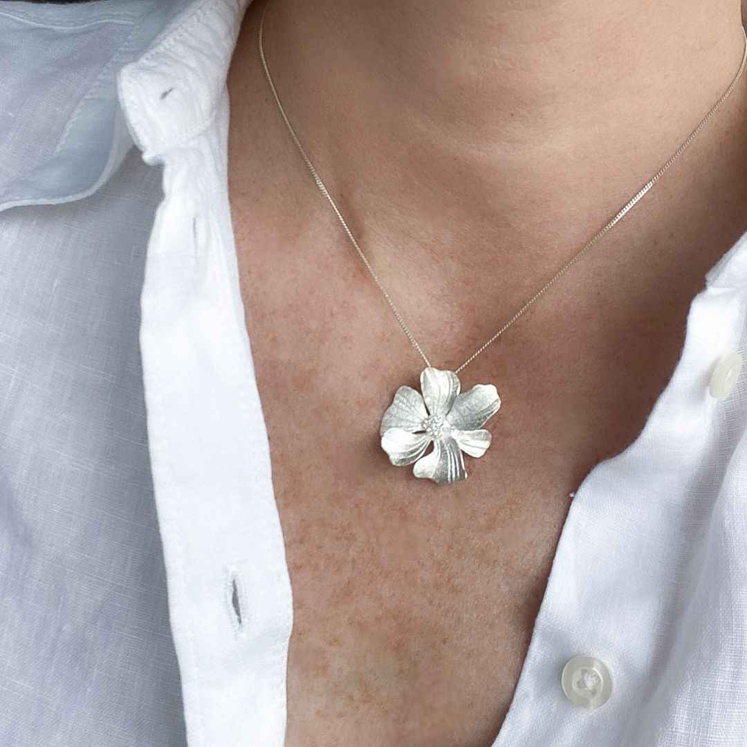 Close-up View of Silver Peony Pendant Necklace, Intricate Detailing and Versatile Accessory for Any Occasion.