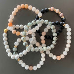 Close-up view of Black Agate and Sesame Stacking Bracelets highlighting the variation of colors.