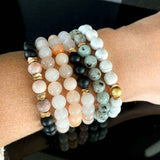 Stacked view of Black Agate and Sesame Stacking Bracelets emphasizing the boho-inspired charm.