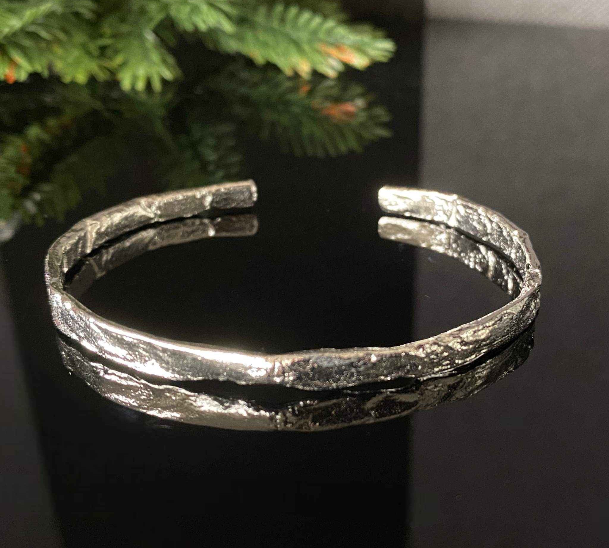 Close-up of the luxurious foil texture on the silver bangle for women.