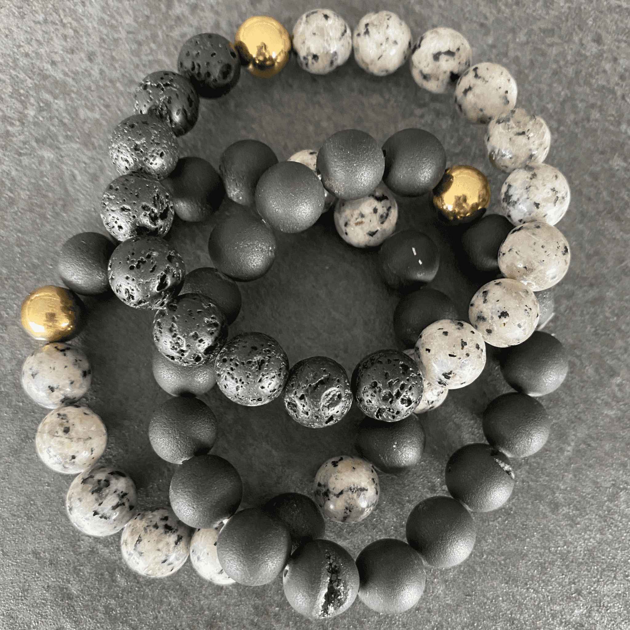 Close-up view of Black Lava Stone and Druzy Agate Bracelets, highlighting the porous black beads and shimmering druzy agate.