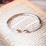 Side perspective of the Silver Tuxedo Bangle showcasing its hinged arms and shimmer.