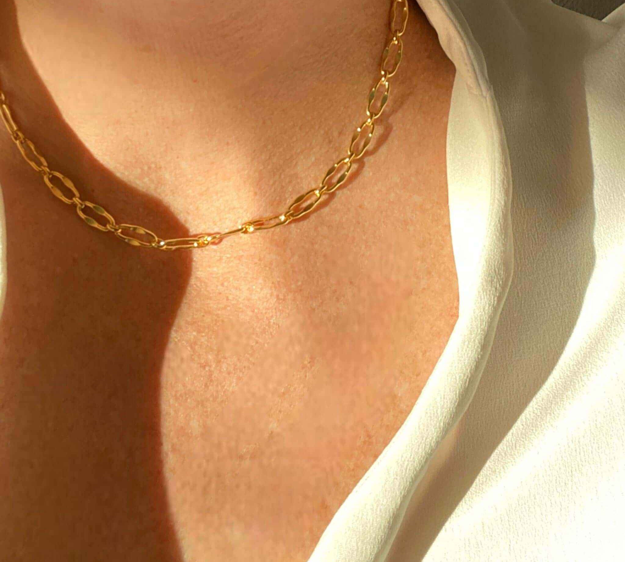 Close-up view of the T-Bar Link design in gold, a modern jewelry piece by Alessandra James.