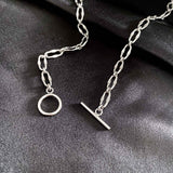 Styled view of the T-Bar Link Necklace in silver, a versatile piece for both casual and formal wear.