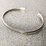Close-up view of Delicate Teardrop Bangle in Silver, Perfect for Sophisticated Looks.