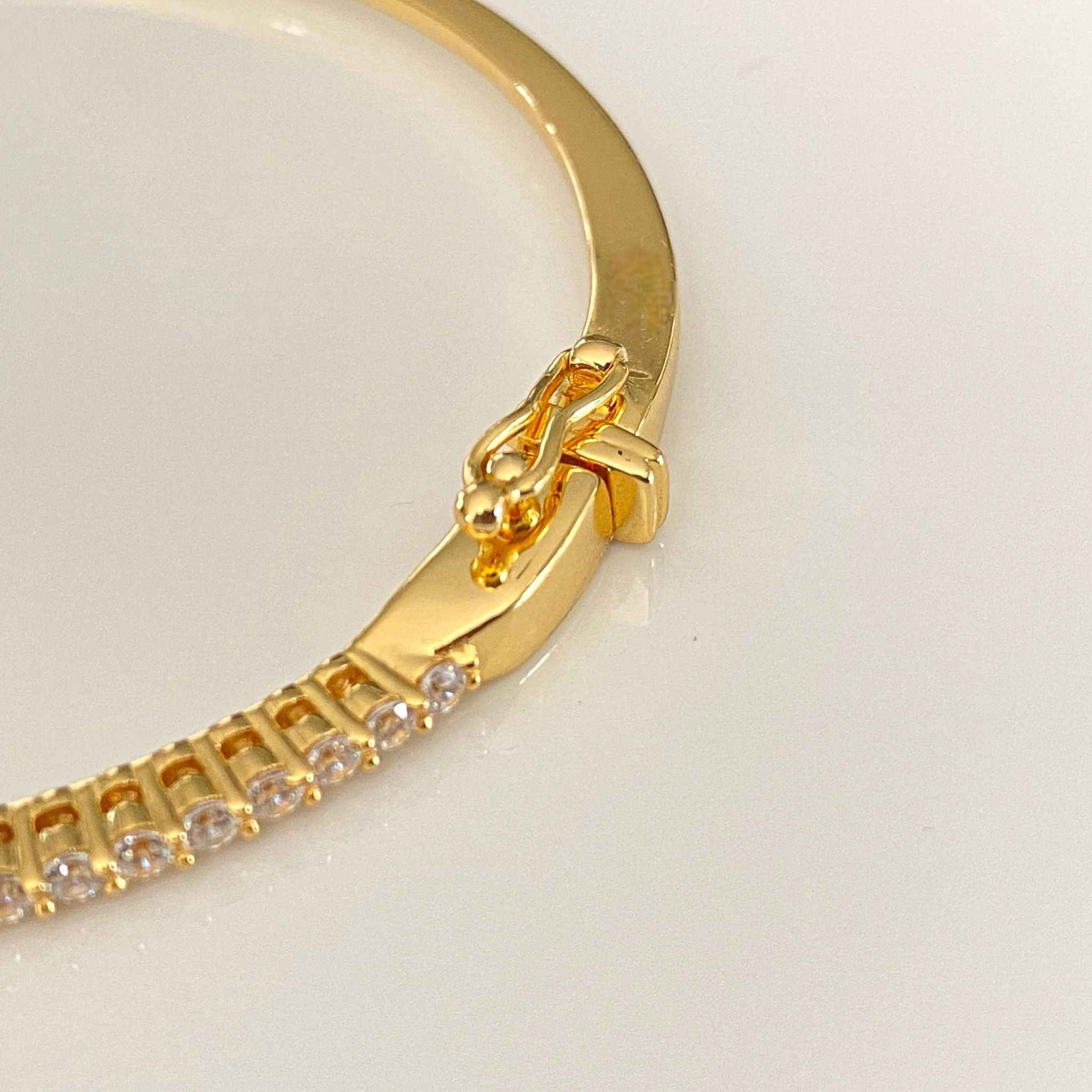 Close-up view of Waverly Gold Bangle clasp by Alessandra James.