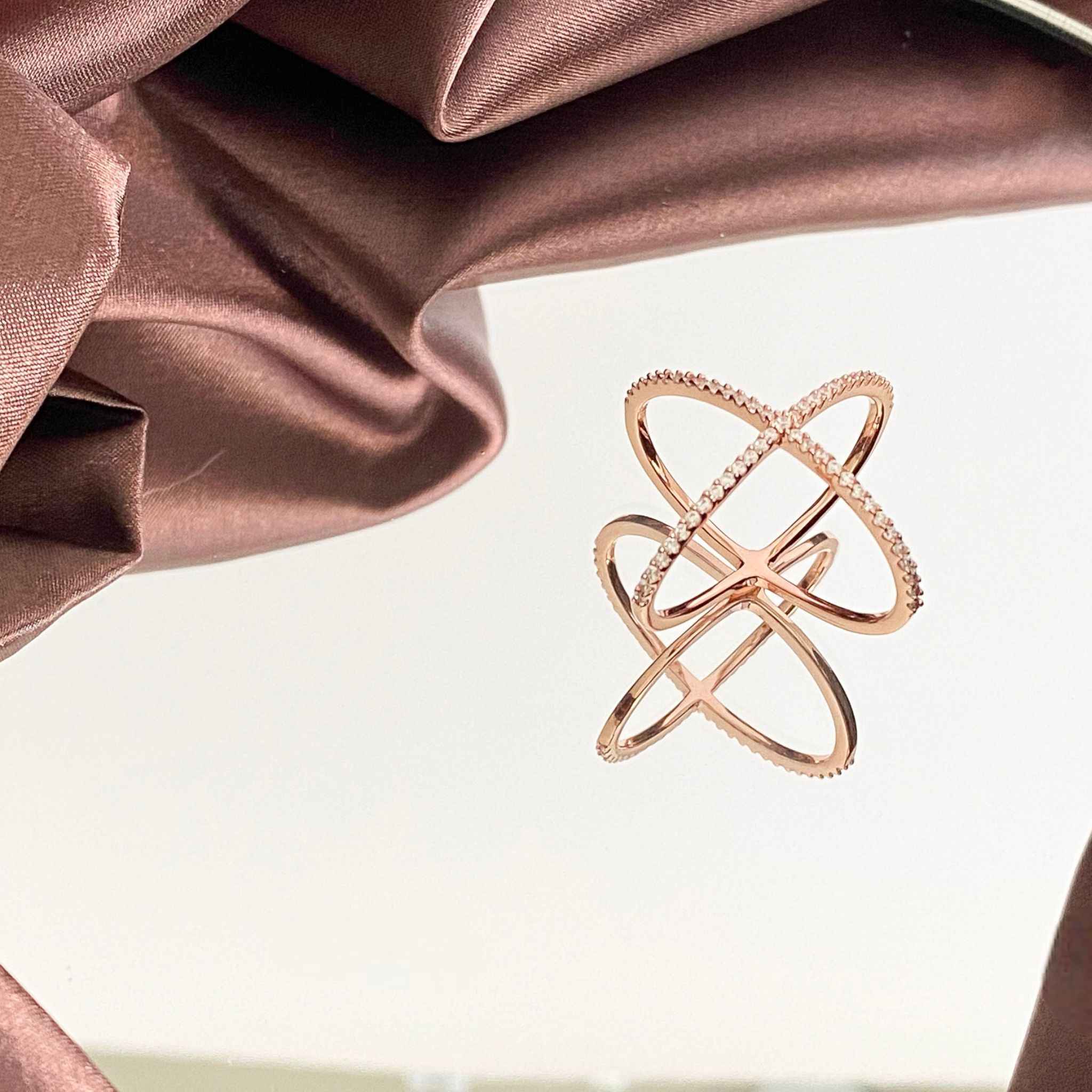 Close-up view of Waverly Cross Ring in Rose Gold showcasing its intricate design and shimmering stones.