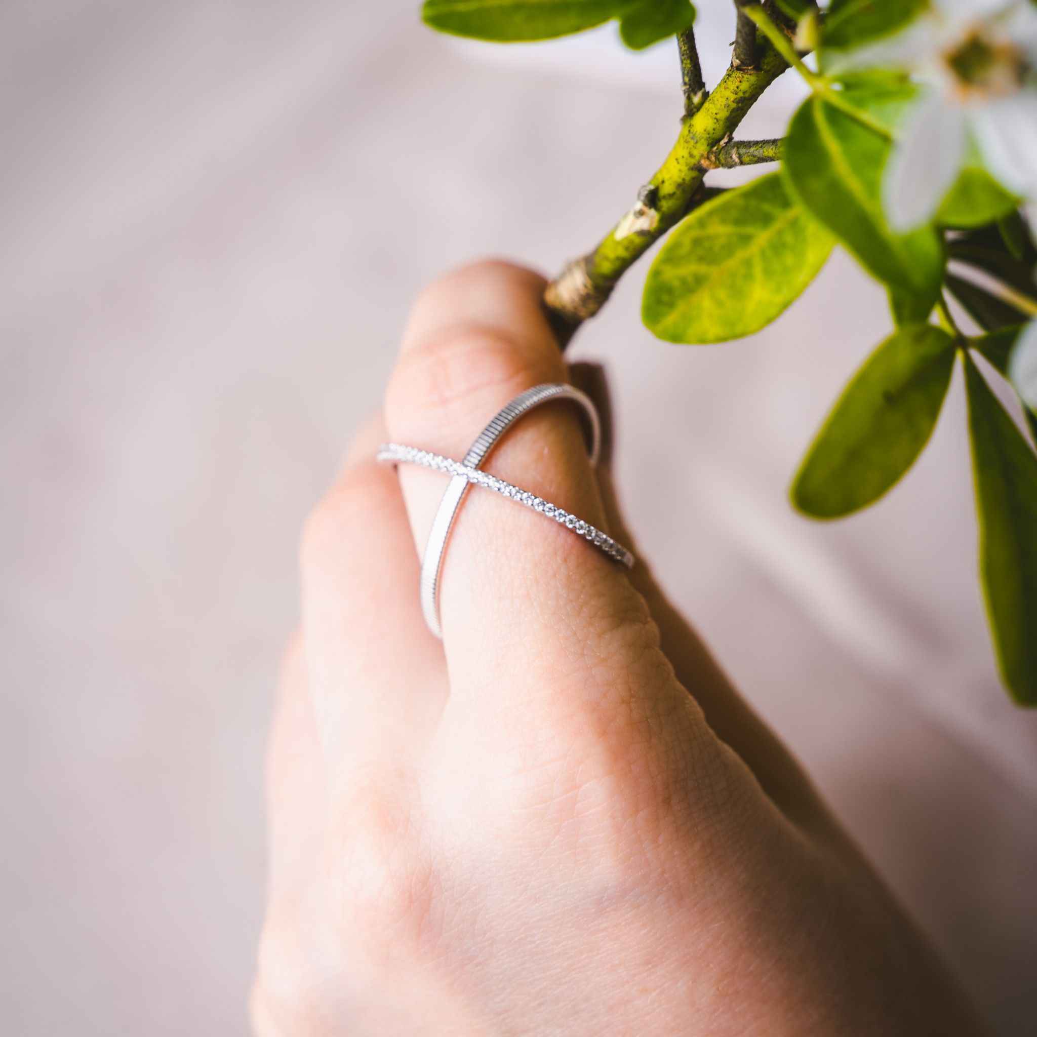 Close-up view of Waverly Silver Cross Ring showcasing its matte band and etching pattern.