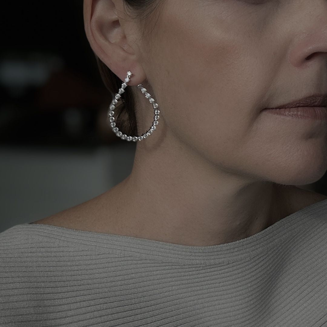 Closeup of woman wearing Elena Teardrop Earrings, showing the unique design and CZ detail.