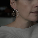 Closeup of woman wearing Elena Teardrop Earrings, showing the unique design and CZ detail.