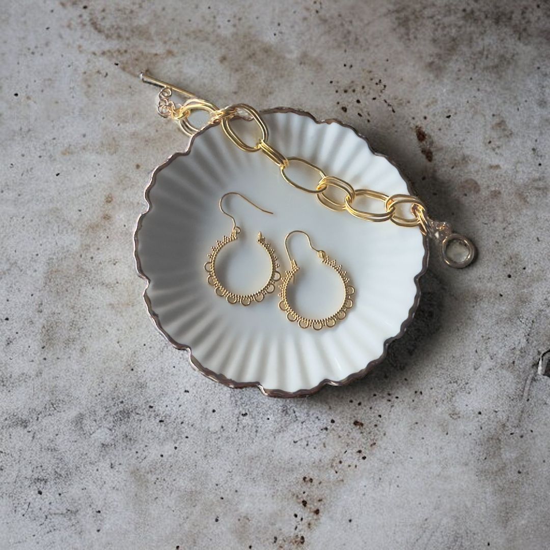 A closeup view of Lacy Vintage Hoop Earrings, showcasing the delicate scalloped edging. 